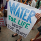 Demonstrators hold signs as they protest against the Detroit Water and Sewerage Department July 18, 2014, in Detroit. The department has disconnected water to thousands of Detroit residents who are delinquent with their bills.
Joshua Lott/Getty Images